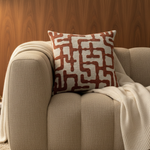 BRONS sierkussen Estoi brique op een taupe bank met crème plaid